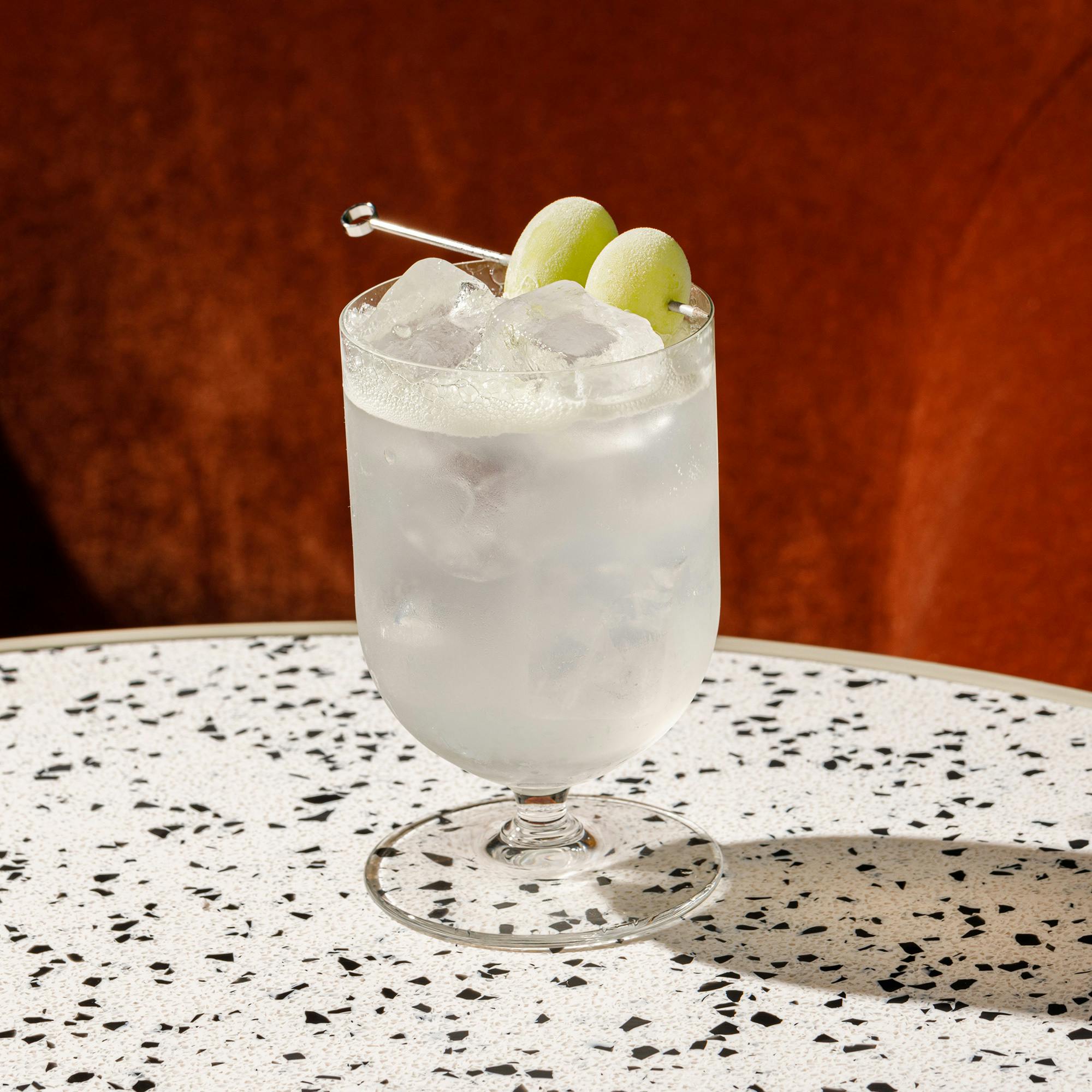 A cool cocktail with ice and olives.